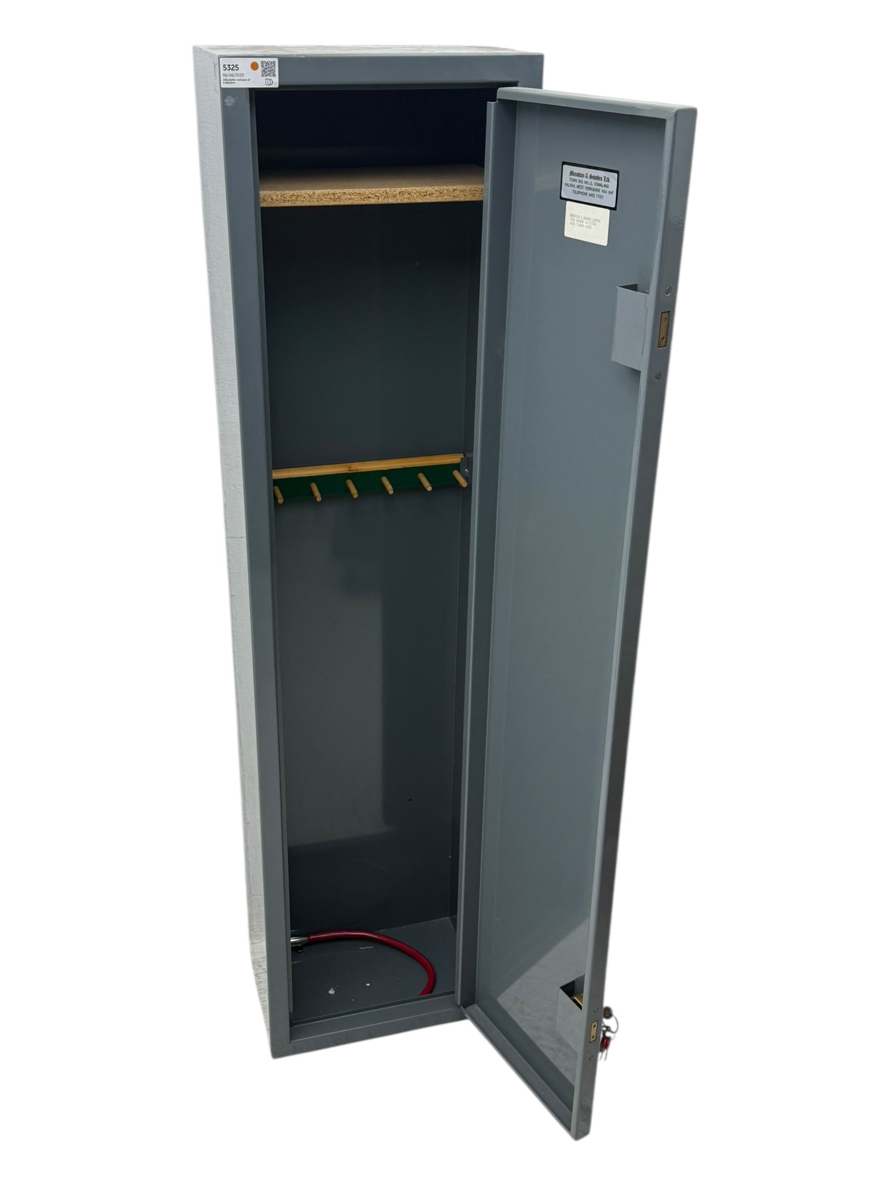 Mountain & Sowden Ltd - painted grey steel construction with single door secured by 7 lever lock, interior fitted with green felt-lined barrel rest, fixed shelf