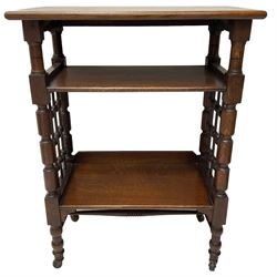 Late 19th century oak three-tier stand or bookcase, on turned supports with lattice sides, on turned feet with castors