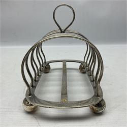 Silver plate seven bar toast rack, of curved form with central ring handle, upon bun feet, H13cm 