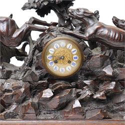 19th-century-8-day German Black Forest mantel clock c1880, with a carved oak case depicting a hunting scene with a stag pursued by hounds amidst rockwork and oak foliage, fitted with a French Parisian movement with a cast brass dial enclosed within a glazed brass bezel with a pendulum adjustment arbor, cartouche blue-on-white enamel  Roman numerals, engraved five minute Arabic's and contrasting steel Fleur-di-Lis hands, twin train going barrel movement with a recoil anchor escapement and countwheel strike. With pendulum.  
