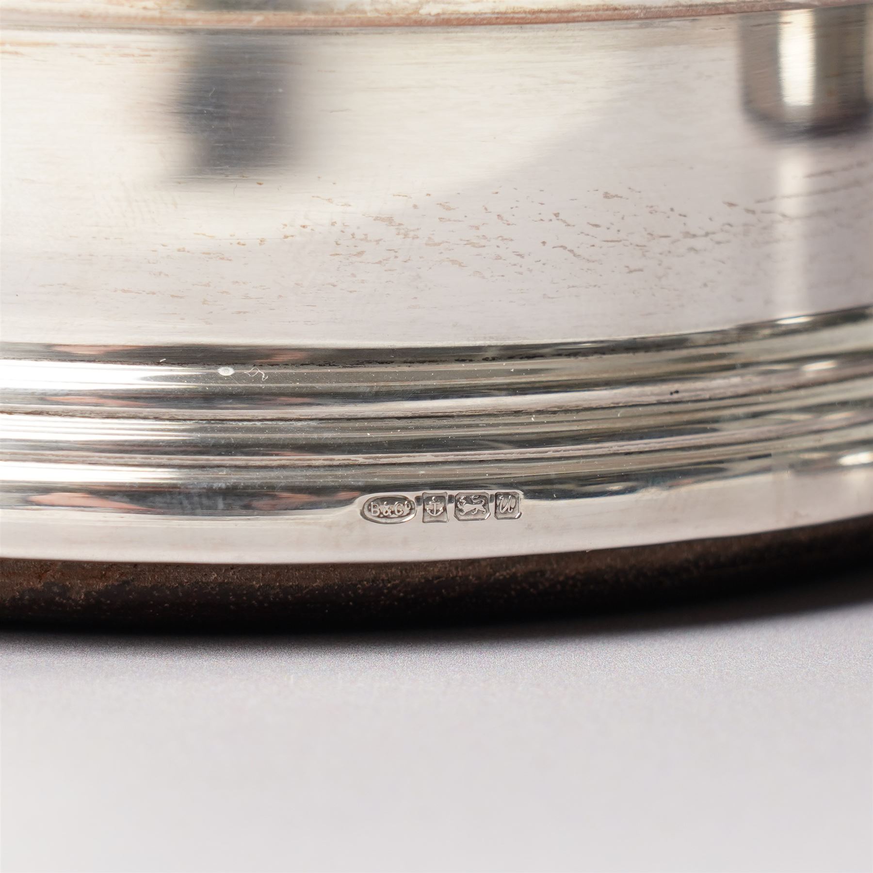 Pair of Elizabeth II silver bottle coasters with turned wooden bases D12cm, Birmingham 1994 Maker W I Broadway & Co.