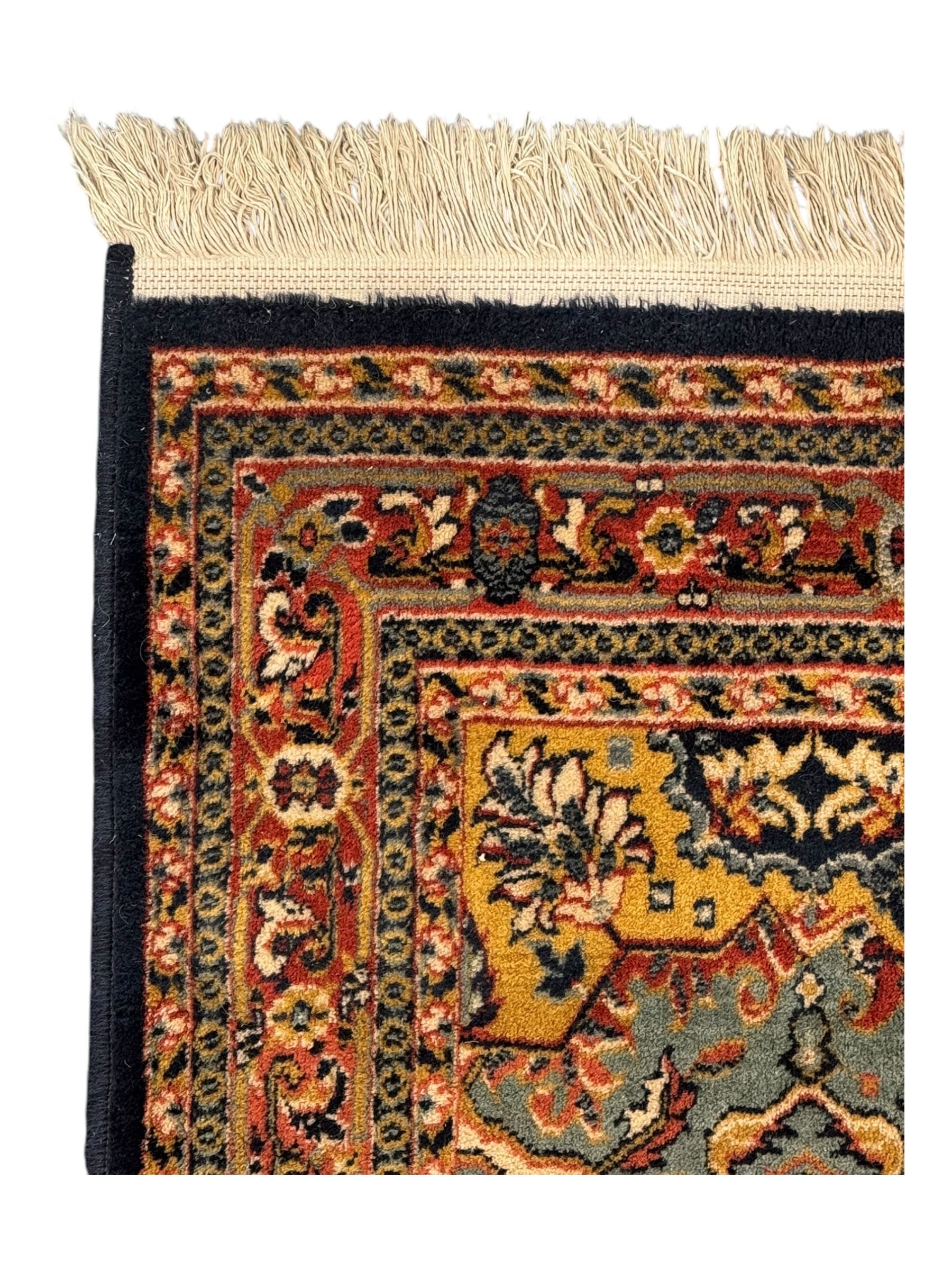 Belgian Sultan woollen ground rug, central navy field densely decorated with floral sprays and geometric patterns (192cm x 135cm); handwoven tribal terracotta ground rug (121cm x 71cm); Persian crimson ground runner, all over stylised floral and foliate motifs (266cm x 94cm)
