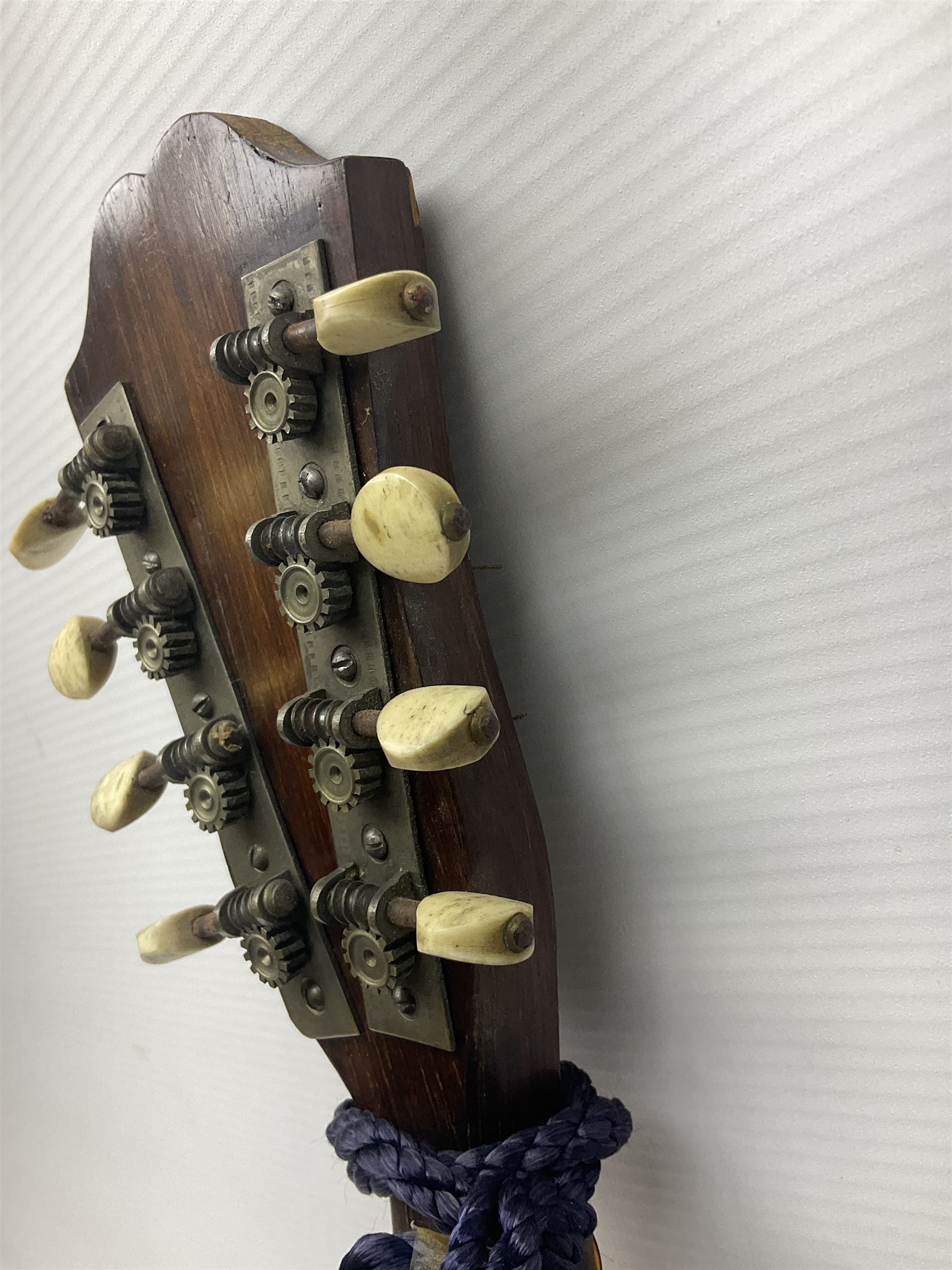 Late 19th/early 20th century Italian lute back mandolin with segmented back and spruce top; bears maker's label for Pietro Tonelli Napoli; together with a mandolin instruction booklet and a folding music stand L60.5cm