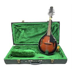 Stagg eight-string mandolin, model M20, the black lacquered body with simulated ivory trim, bears label numbered 070465 L70cm; in green painted scratch-built wooden case