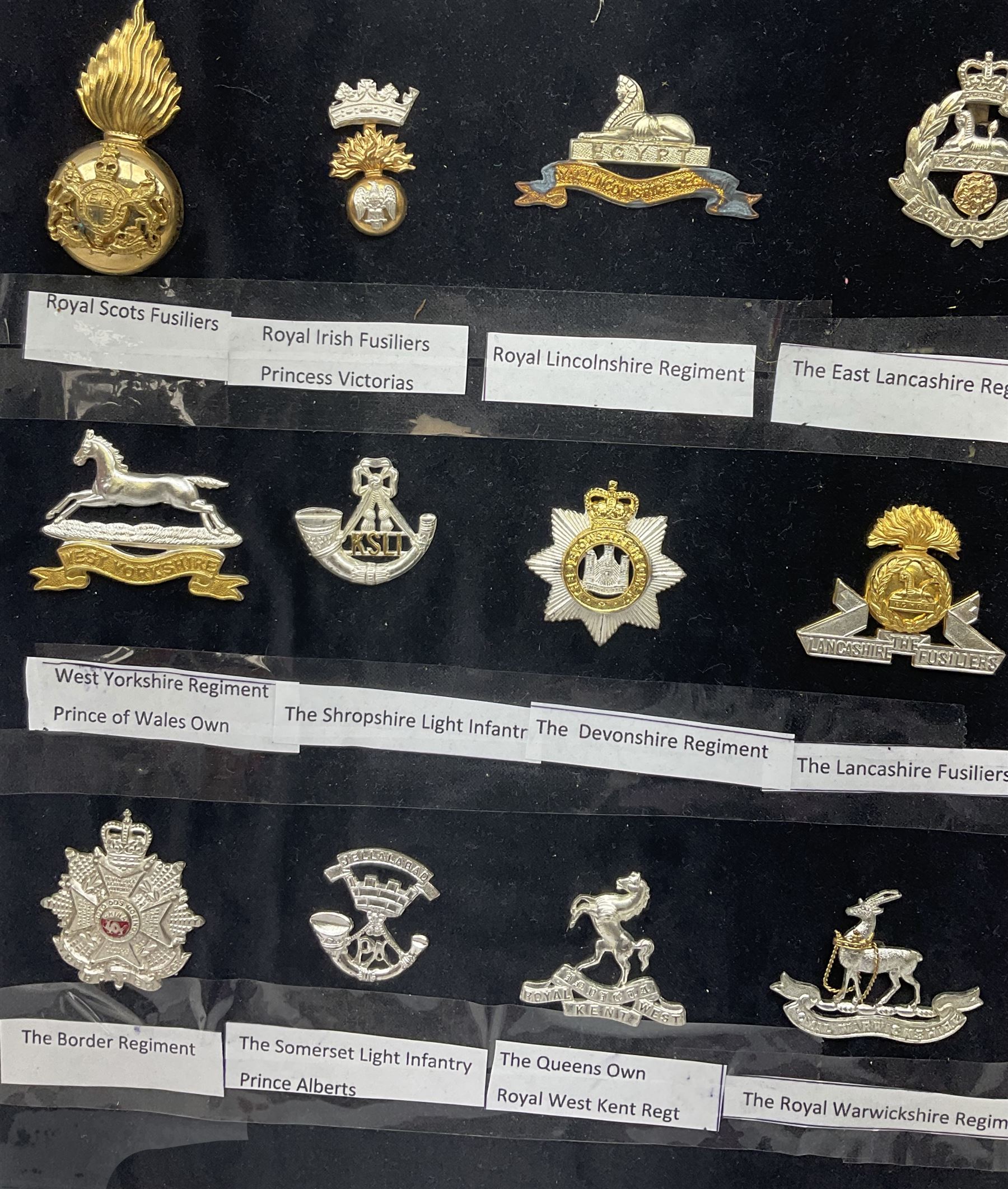 Collection of thirty-two reproduction military badges, including Royal Scots Fusiliers, Royal Lincolnshire Regiment, The Boarders Regiment etc. 