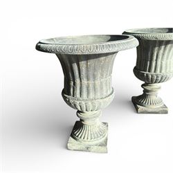 Pair of cast iron Urns on square bases