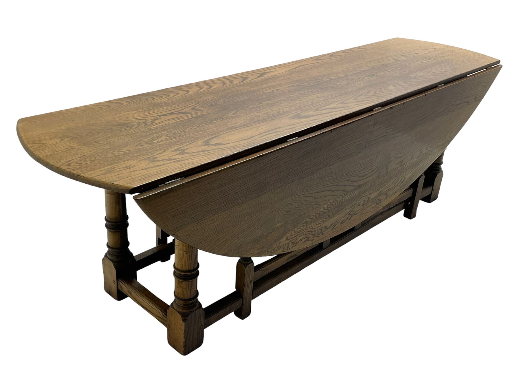 Large 18th century design oak wake or dining table, oval drop-leaf top, turned supports with double gate-leg action base, united by moulded stretchers 