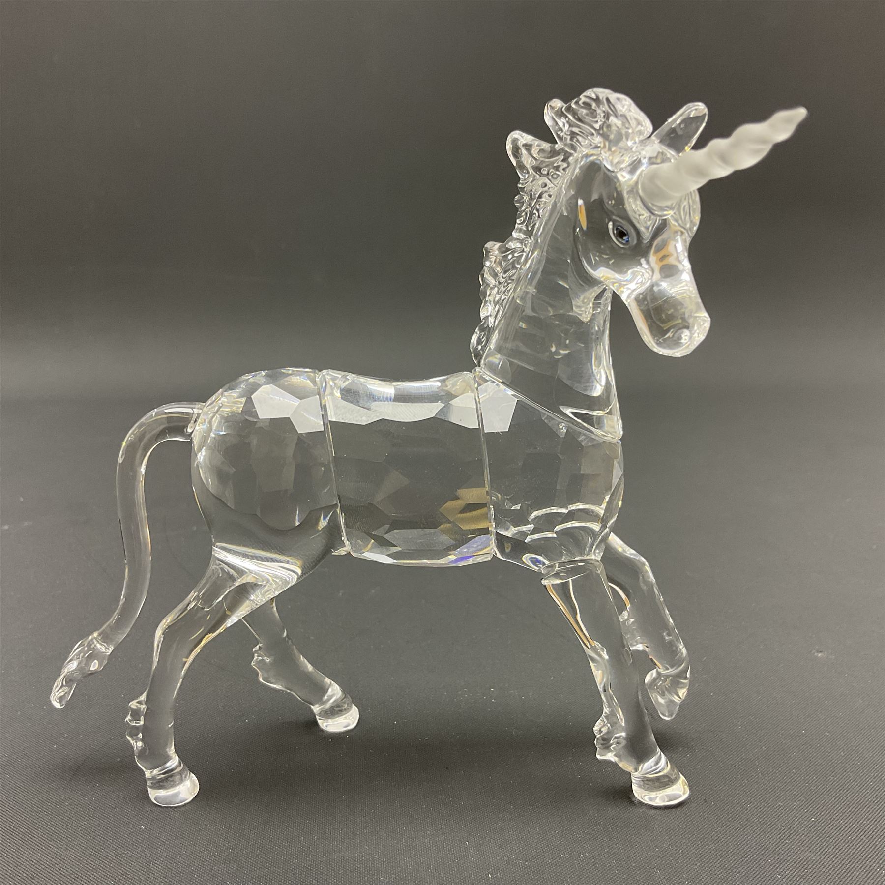 Swarovski Crystal animals, comprising white peacock, the tail with cascading blue flowers, perched eagle with yellow beak, ibex with frosted crystal horns and unicorn with frosted crystal horn, tallest H13cm