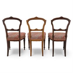 Set of six late Victorian mahogany dining chairs, the shaped top rails carved with anthemion motifs, above pierced splats, floral and geometric fabric seat, on turned and fluted front legs