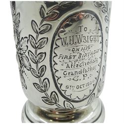 Early 20th century silver christening cup, with scroll handle and upon circular stepped foot, the body chased with floral sprays flanking a personally engraved oval panel, hallmarked Chester, probably 1902, makers mark worn and indistinct, together with a late Victorian silver pepperette of urn form, hallmarked Jay, Richard Attenborough & Co, Chester 1897, a silver open salt of cauldron form, (hallmarks worn and not visible), and an early 20th century silver pepper of egg form upon three ball feet, approximate total weight 6.26 ozt (195 grams)