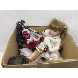 Two decorative wicker dolls prams, one with lace parasol,  and eleven dolls, including Leonardo Collection porcelain dolls, tallest pram including parasol H105cm