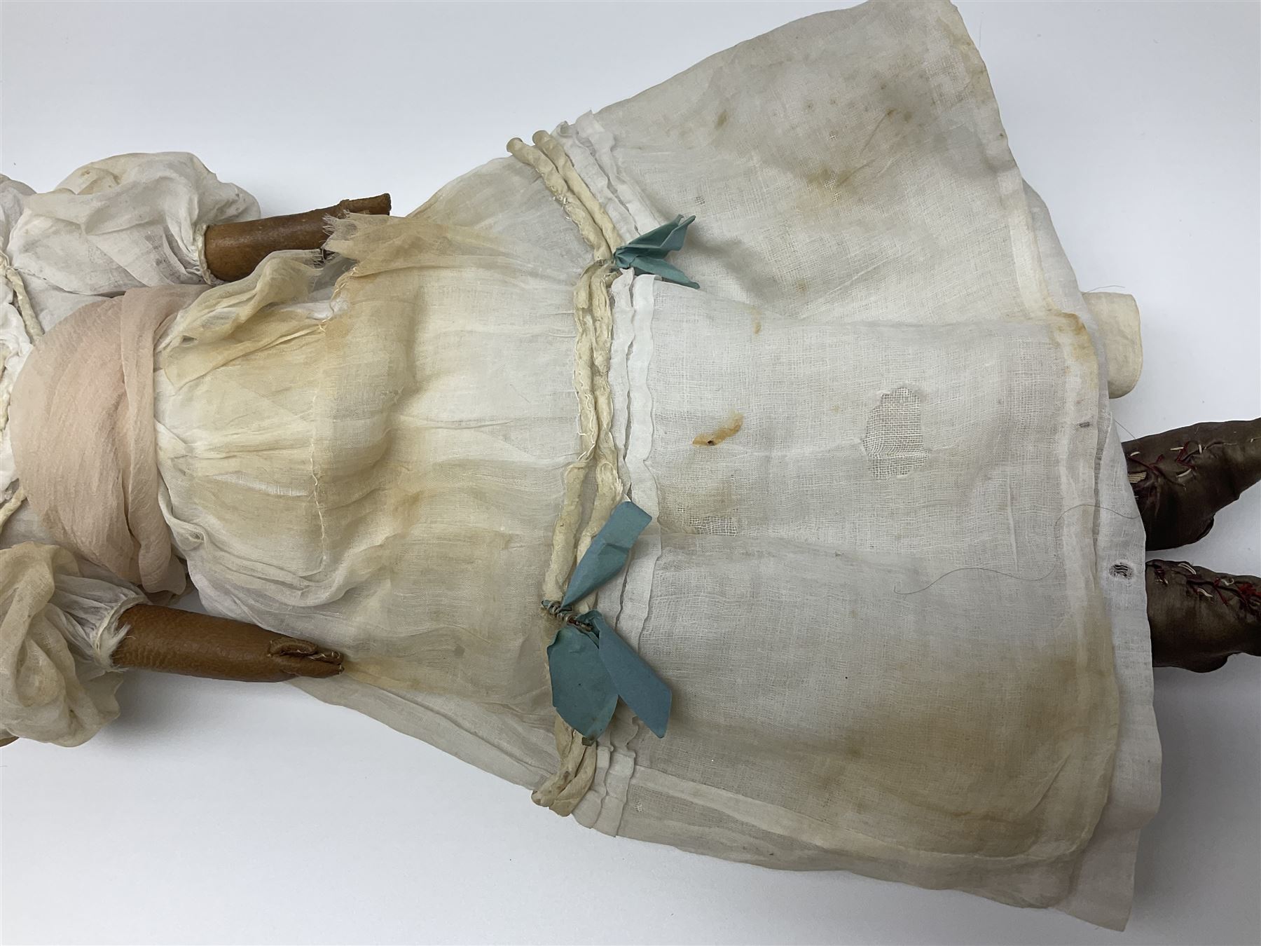 Victorian wax shoulder head doll with pale complexion, applied hair, inset glass eyes and fabric covered jointed body with kid leather lower arms; white linen dress and undergarments H50cm