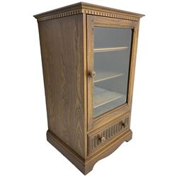 Ercol - mid-20th century dark elm 'Old Colonial' music cabinet, single glazed door enclosing three shelves, single drawer fitted to base