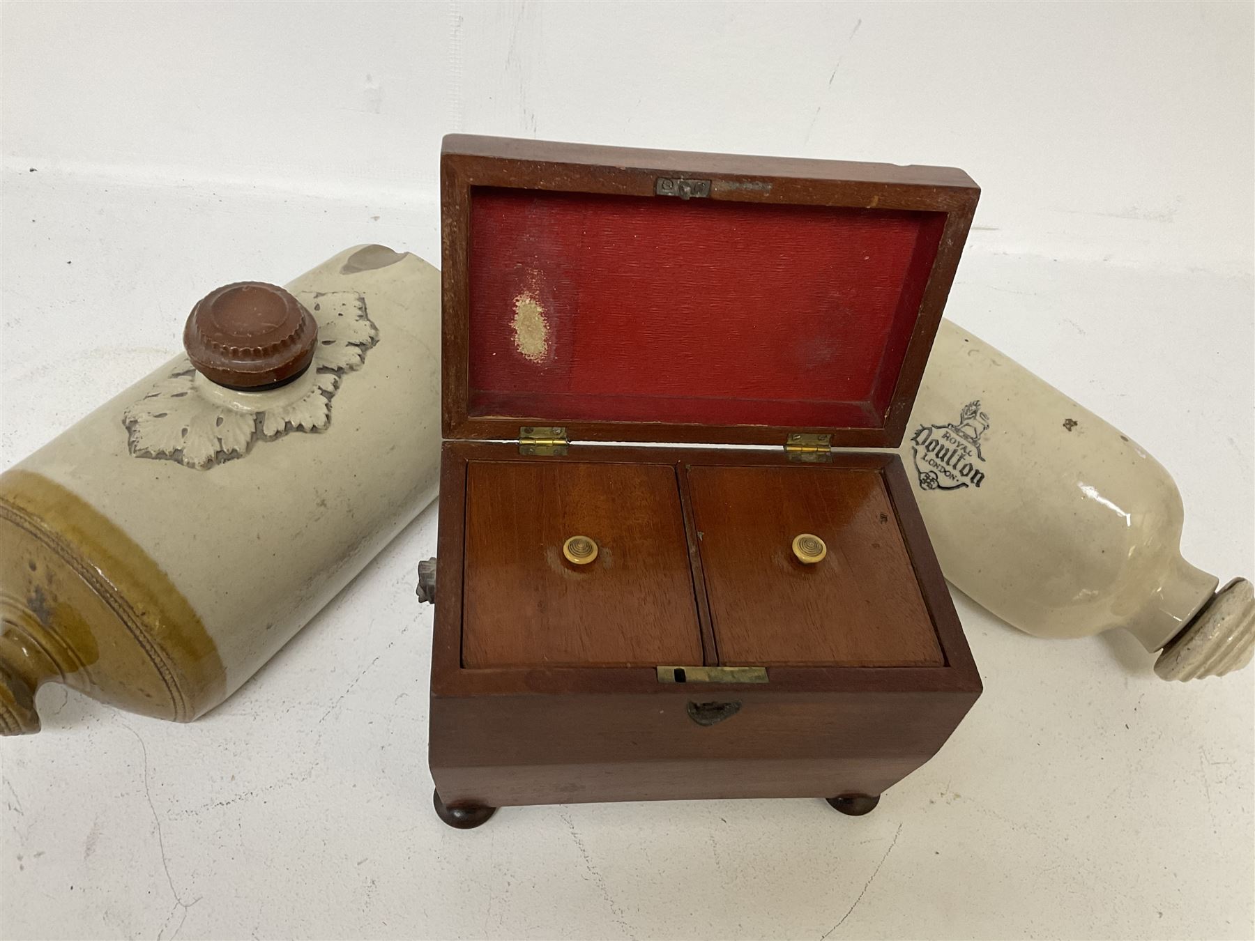 sarcophagus shaped tea caddy with bun feet, together with two stone hot water bottles, caddy H17cm 