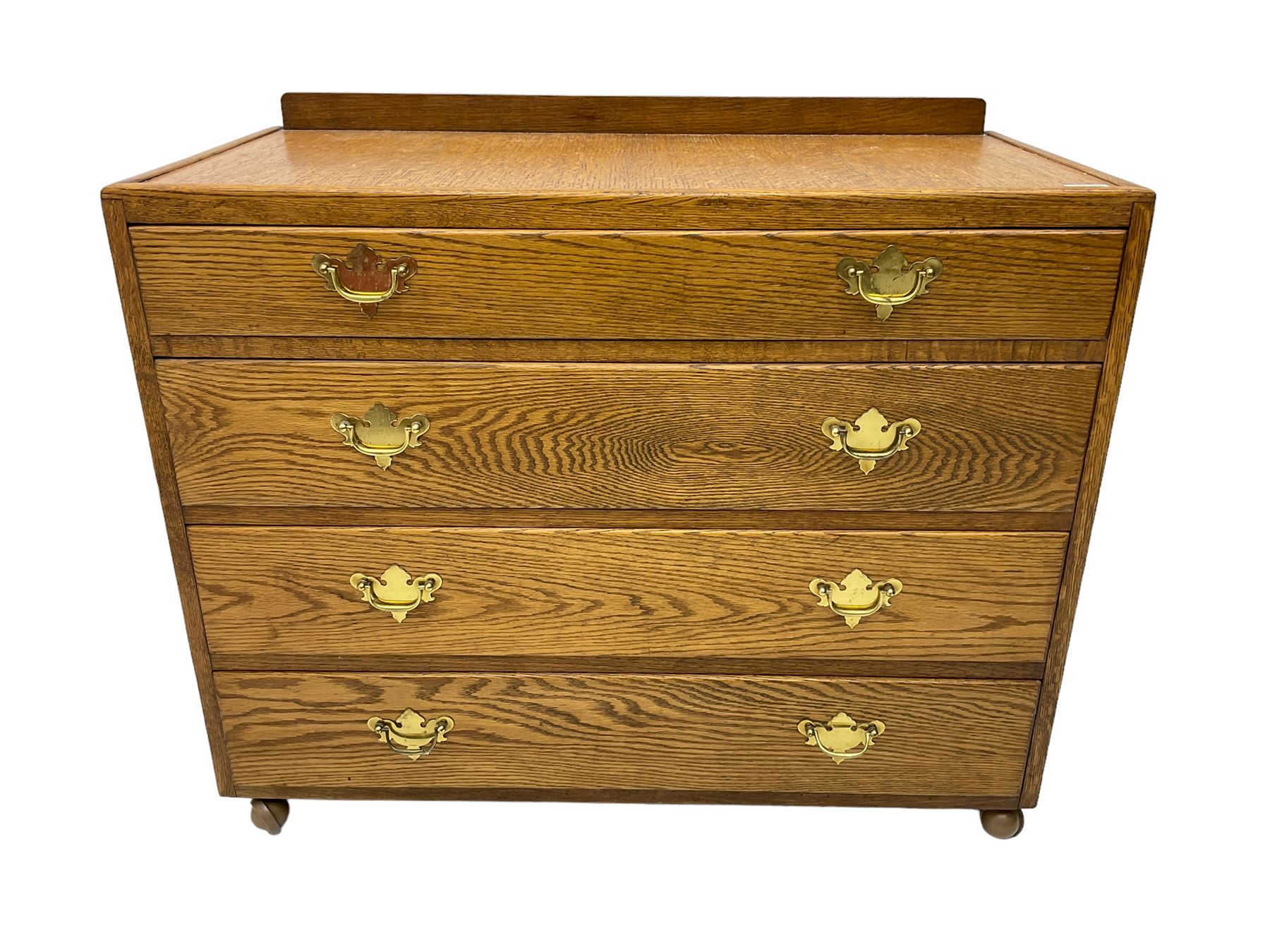 Mid-20th century oak chest, raised back, fitted with four graduating drawers, on castors