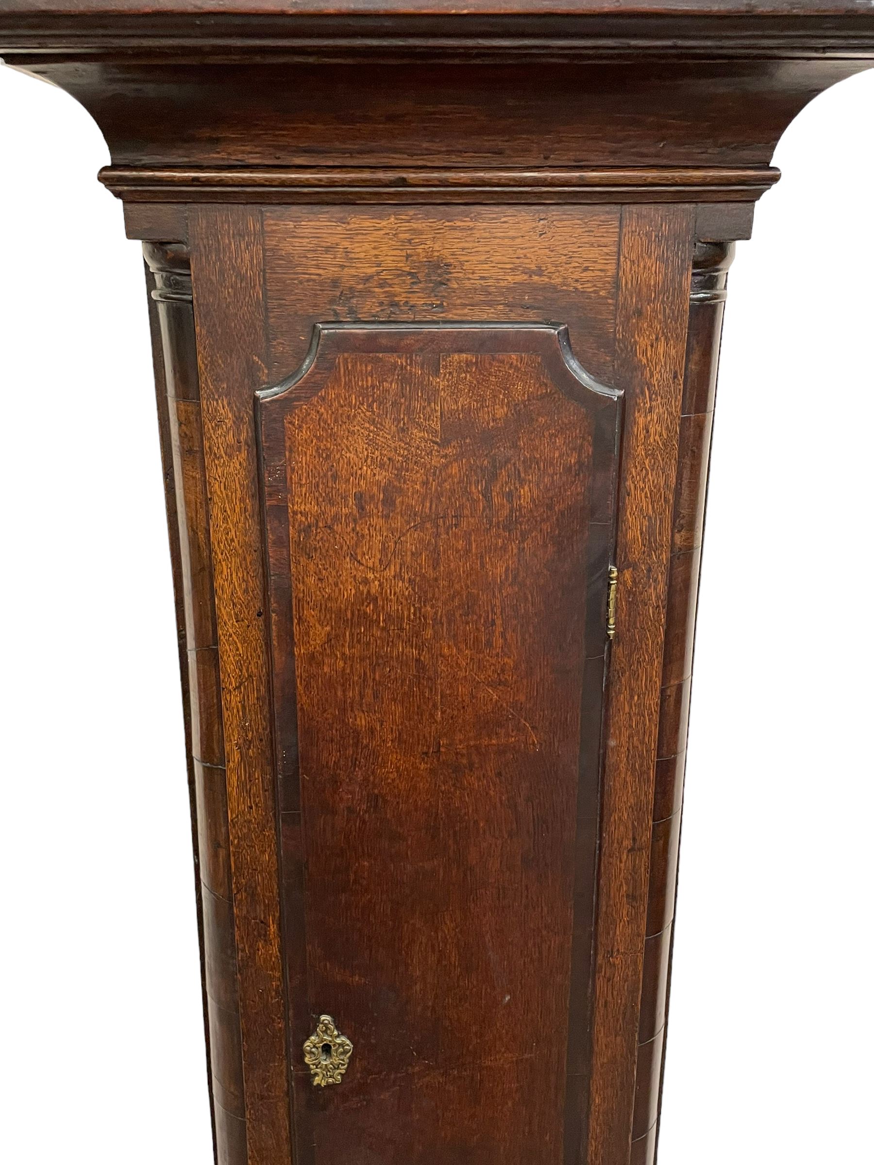 William Lister (II) of Keighley – 8-day 18th century oak cased longcase clock c1760, hood with a break front flat topped pediment and eglomise  frieze beneath, square hood door flanked by matching pilasters with gesso capitals, trunk with quarter columns and long trunk door with a flat top and convex shoulders, square plinth with a decorative skirting, 12” brass dial with rococo spandrels, engraved dial center, silvered chapter with Roman numerals, five minute Arabic’s, half hour markers and minute track, semi-circular apertures with engraved calendar and moon phase/lunar age discs, original blue steel fretted hands, four pillar rack striking movement with a recoil anchor escapement, striking the hours on a bell. With pendulum, weights and key.
The Lister family were a prolific family of clockmakers working in the West Riding of Yorkshire during the 18th century. Working in various locations including Halifax, Keighley and Luddenden.
William Lister (I) is recorded as working in Keighley from 1715-37 and his son William (II) from 1735-1785.
