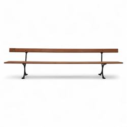 Pine garden bench, with stained and weatherproof varnish, single slat pine seat and back, raised on curved black cast iron supports