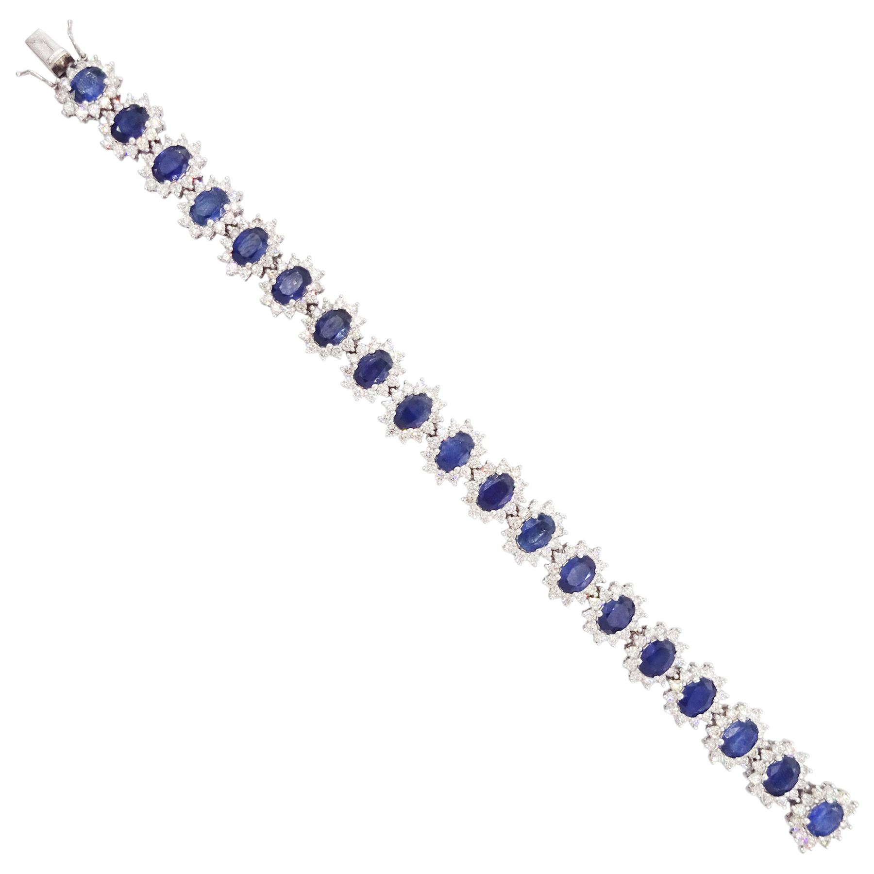 18ct white gold sapphire and diamond bracelet, nineteen clusters each set with a single oval cut sapphire and round brilliant cut diamond surround, stamped 750, total sapphire weight 18.20 carat, total diamond weight 6.38 carat