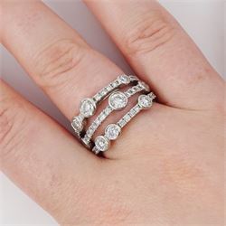 Platinum diamond three row split design ring, nine bezel set round brilliant cut diamonds, spaced by smaller round brilliant cut diamonds, hallmarked, total diamond weight 1.70 carat 
