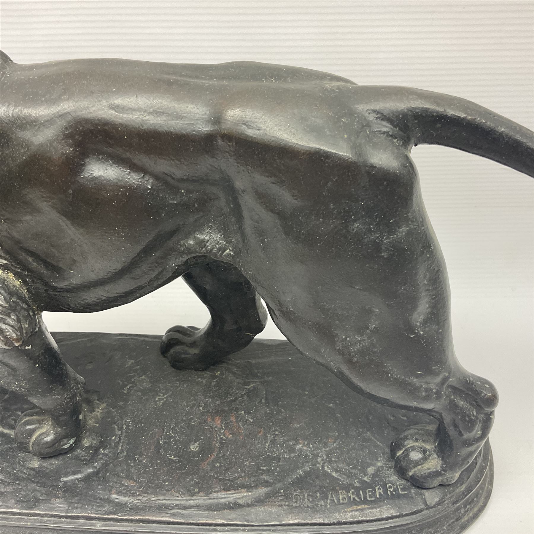 After Paul Edouard Delabrierre (French, 1829-1912), bronze, model of a lion, upon an oval base, signed E Delabrierre, overall H29.5cm, L46cm