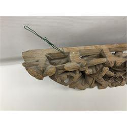 Two carved oriental wall hangings, the first example gilded depicting a temple and garden scene, the second figures in a garden, L49cm