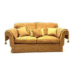Grande two seat sofa upholstered in red and gold damask fabric with complimentary cushions 