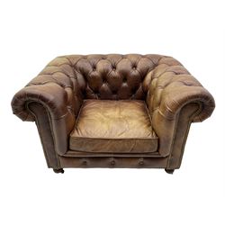 HALO - Chesterfield style armchair upholstered in buttoned brown leather with stud work, on turned feet with castors
