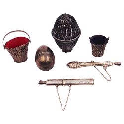 Group of silver sewing accessories, comprising silver filigree case in the form of an egg, unmarked by testing as silver, a modern silver mounted novelty pin cushion modelled as a basket with swing handle, hallmarked C M E Jewellery Ltd, Birmingham import, with 925 common control mark and also stamped 925, silver mounted thimble holder modelled as a basket, unmarked by testing as silver, a thimble case in the form of an egg, also unmarked but testing as silver, and two needle cases, the bails stamped 925 