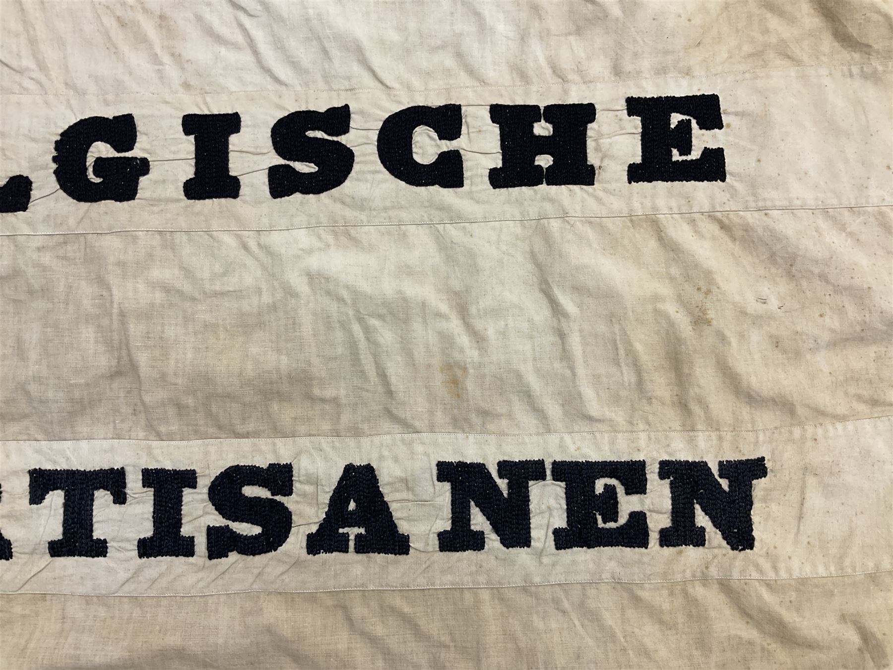 WW2 Belgian Partisan/Resistance two-sided banner embroidered in black on a cream ground 'Belgische Partisanen Korps 032 afd: Ph: De Bruyne' within a Belgian flag border; on wooden pole with gilded metal lion and laurel wreath finial