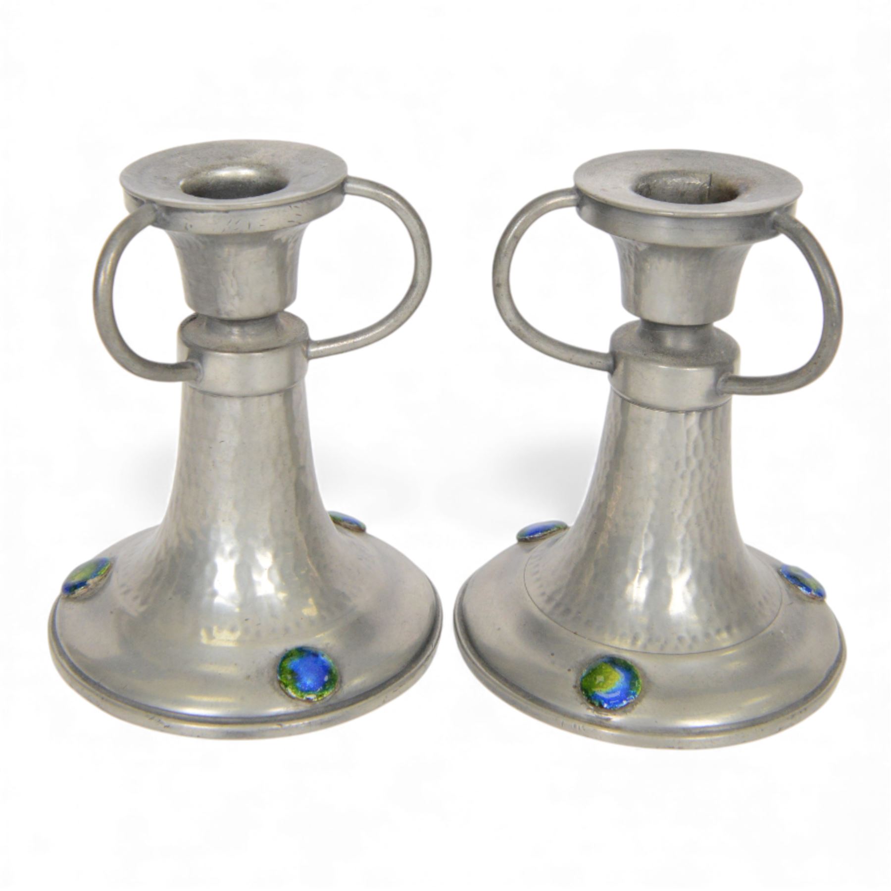 Pair of  Jugendstil hammered pewter candlestick each set with three blue and green enamel roundels, marked Germany beneath, H12cm