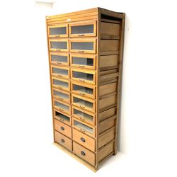 Haberdashery display cabinet with plaque ‘J.C. King Ltd, Shop fittings & Sundries, St John's Street London’, sixteen glazed front short drawers, above four deep drawers