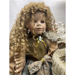 Two decorative wicker dolls prams, one with lace parasol,  and eleven dolls, including Leonardo Collection porcelain dolls, tallest pram including parasol H105cm