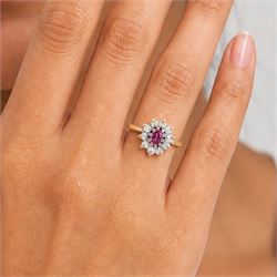 18ct gold pink sapphire and diamond cluster ring, single oval cut sapphire of 0.23 carat, surrounded by ten round brilliant cut diamonds, Birmingham 1985, total diamond weight 0.26 carat