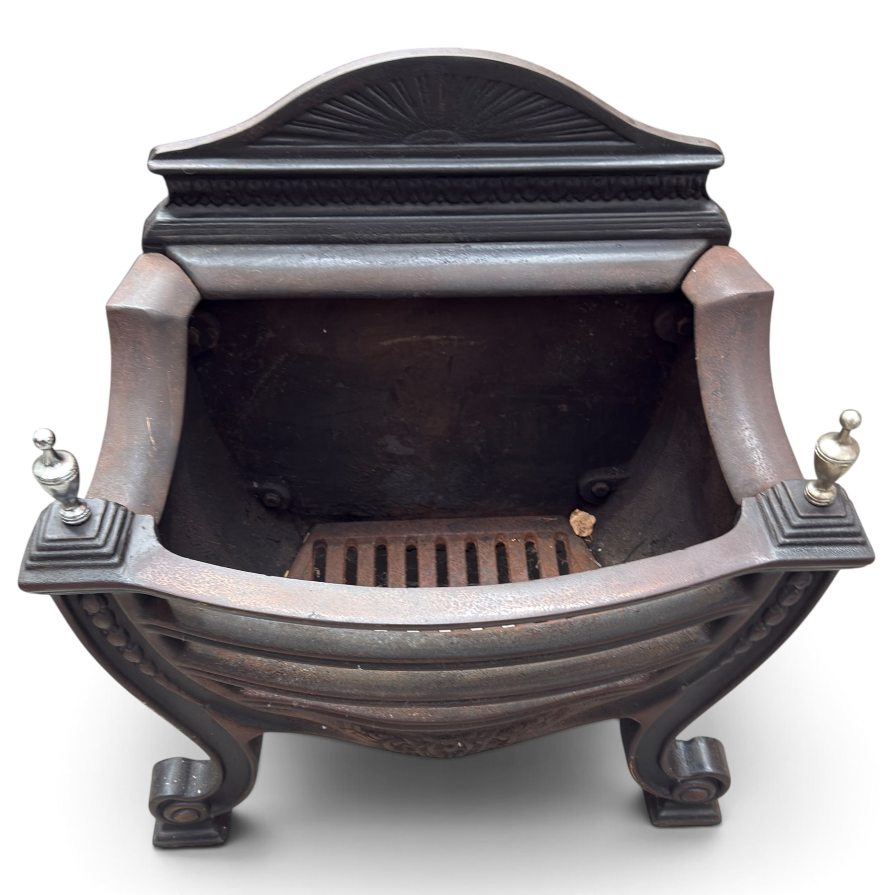 Three cast iron fireplace fittings, comprising a Regency-style fire grate with sunburst crest, urn finials, bowed basket and scroll supports (W58cm H63cm); Victorian fender with pierced acanthus frieze and foliate base (W64cm H20cm); Gothic Revival fireplace with fleur-de-lis crest, arched surround and integral fire basket (W41cm H87cm)