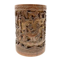 Late 19th century Chinese bamboo brush pot, densely carved with scholars, attendants, and maidens or meiren, within a landscape filled with rocky outcrops, pavilions and trees, with painted character mark beneath, H17cm D12cm

