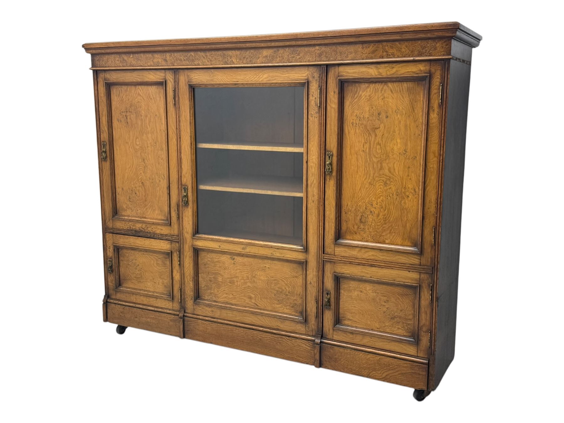 Late Victorian pollard oak bookcase or sideboard, the central glazed door opening to reveal adjustable shelves and interior makers label 