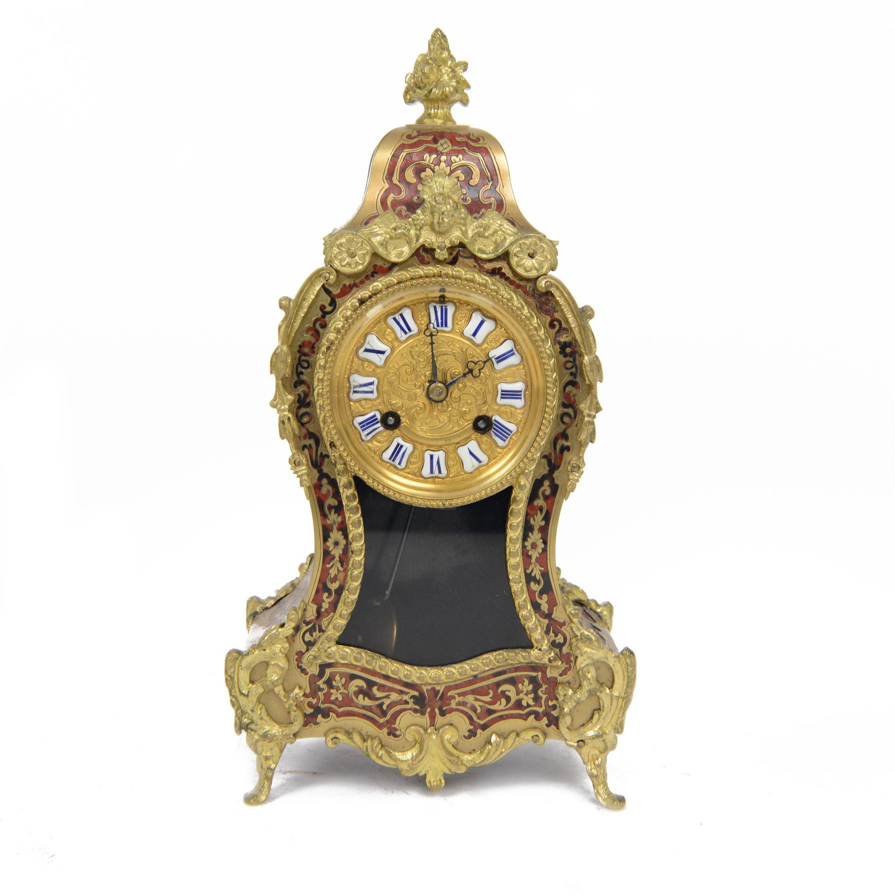 Louis XV-style gilt-bronze mounted turtleshell boulle mantel clock, the case of typical waisted form, gilt bronze foliate scroll and rocaille mounts, raised on scroll feet. Eight-day Paris movement signed “Rollin à Paris”, with outside count-wheel striking half-hourly on a single bell, the going train with anchor escapement. The circular foliate gilt bronze dial with enamelled Roman hour numerals and twin winding apertures, fitted with pierced blue steel hands and bevelled glass cover, with pendulum and key, circa 1860