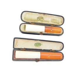 Amber gold mounted cheroot holder, 12.5 ct hallmarked, cased, together with another gold mounted example and various others, and silver mounted pipe 