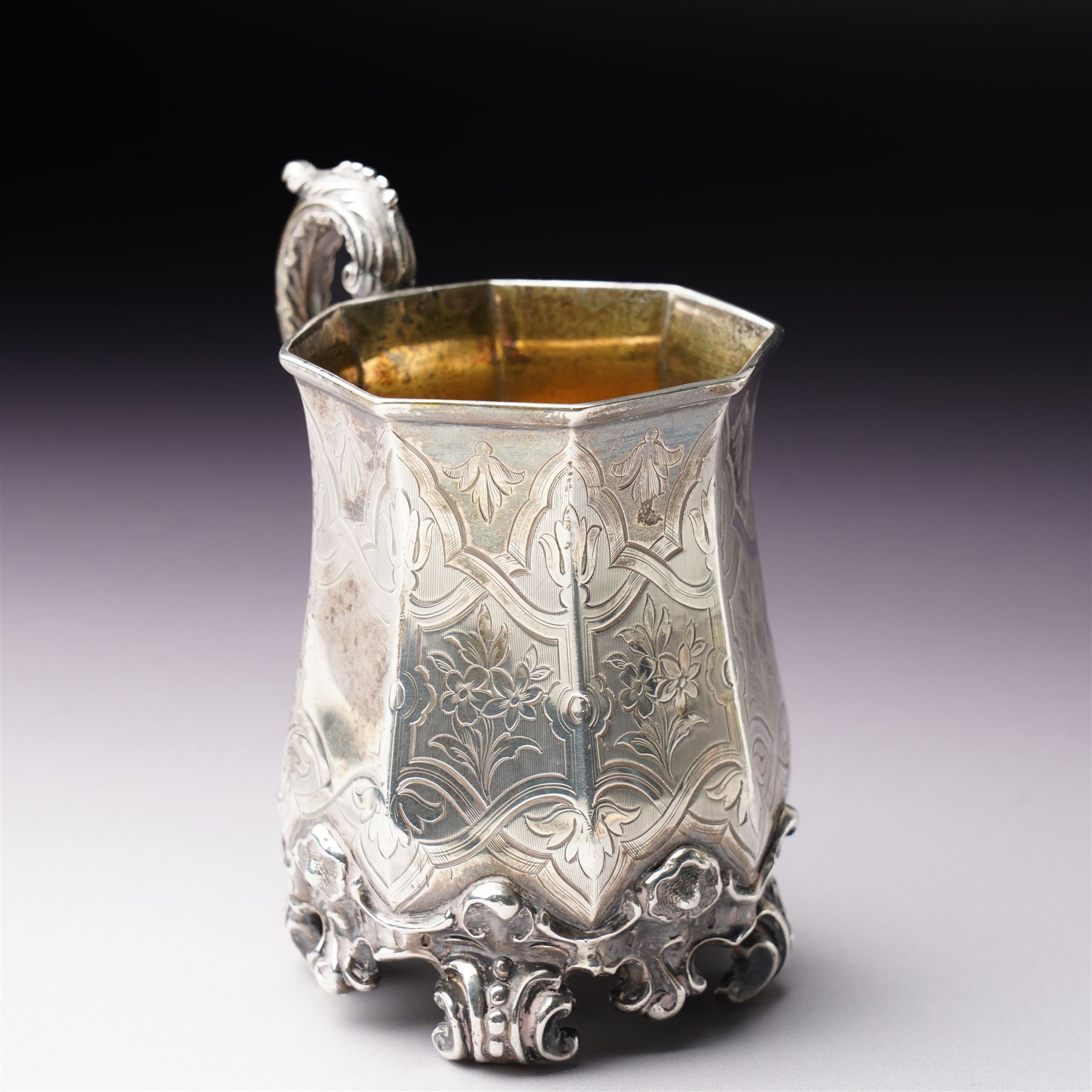 Victorian silver christening mug of panel sided design with gilded interior, engraved decoration and scroll handle and feet H10cm London 1848 Maker Charles Reily & George Storer