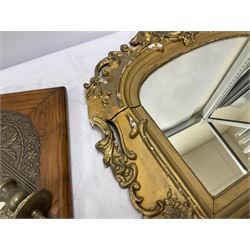 Wall mounted mirror with brass repoussé decoration above twin branched candlesticks, L57cm, together with a further gilt mirror