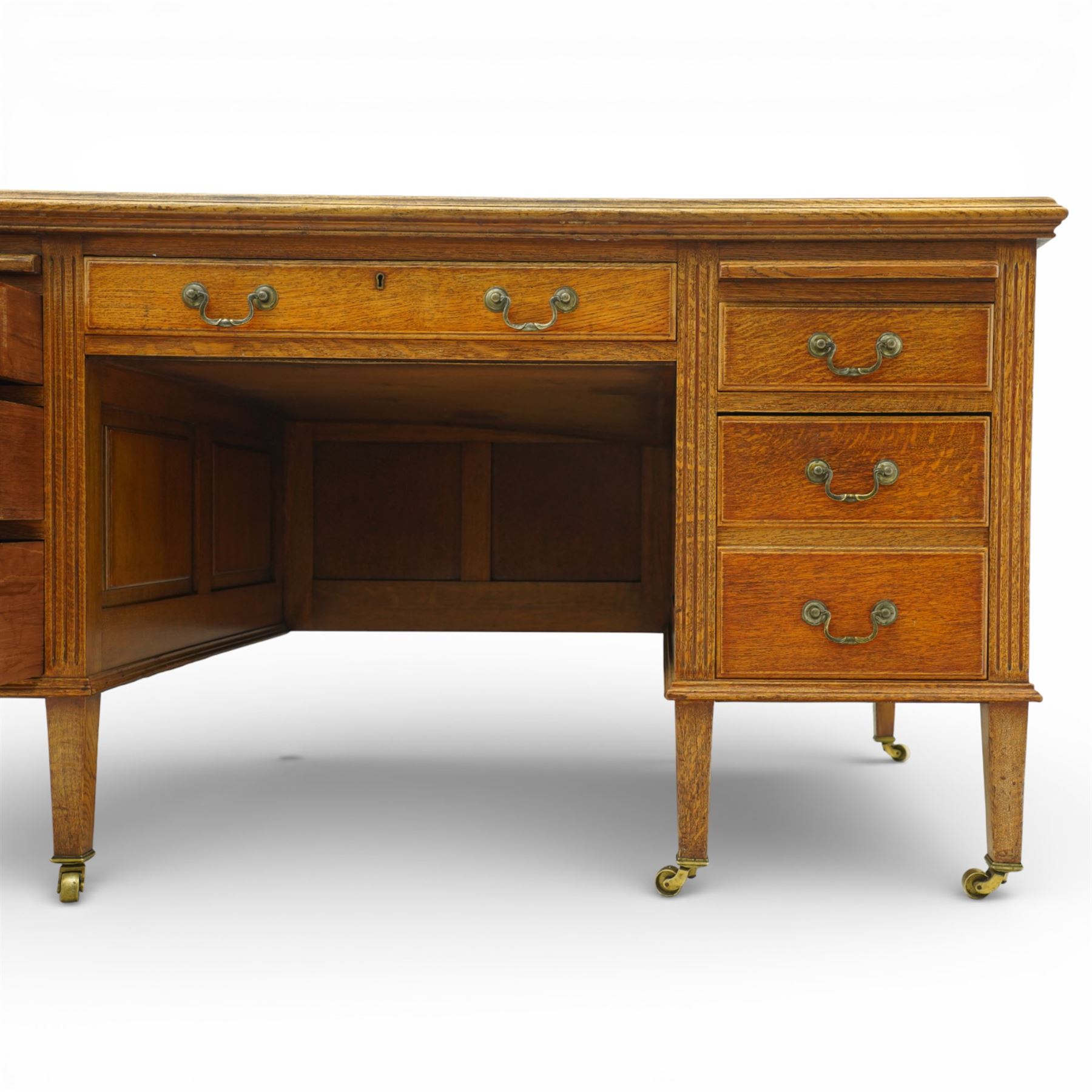 20th century oak kneehole desk, rectangular black leather inset top, above a single frieze drawer, flanked by two pedestals with slides and drawers, panelled sides and back 