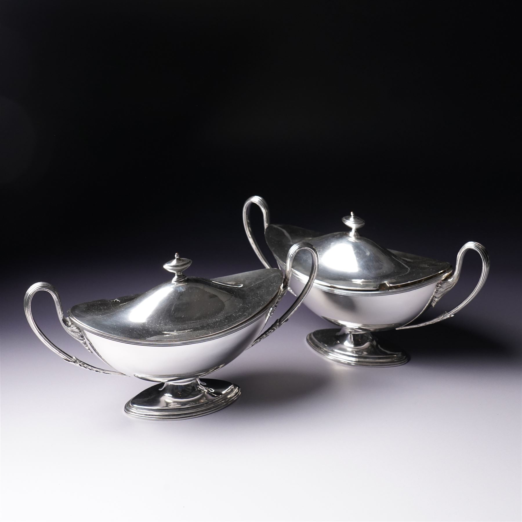 Pair of silver plated sauce tureens and covers of oval form with reeded loop handles L25cm overall