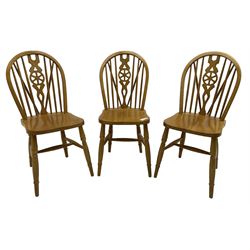 Set of six solid beech Windsor design dining chairs, stick and hoop back with pierced wheel splat, on turned supports united by H-stretchers 