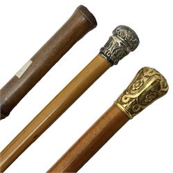 Early 20th century bamboo sword stick with 39cm oblong section blade L85cm overall; and two malacca cane swagger sticks, one with white metal mounts the other with yellow metal mounts (3)