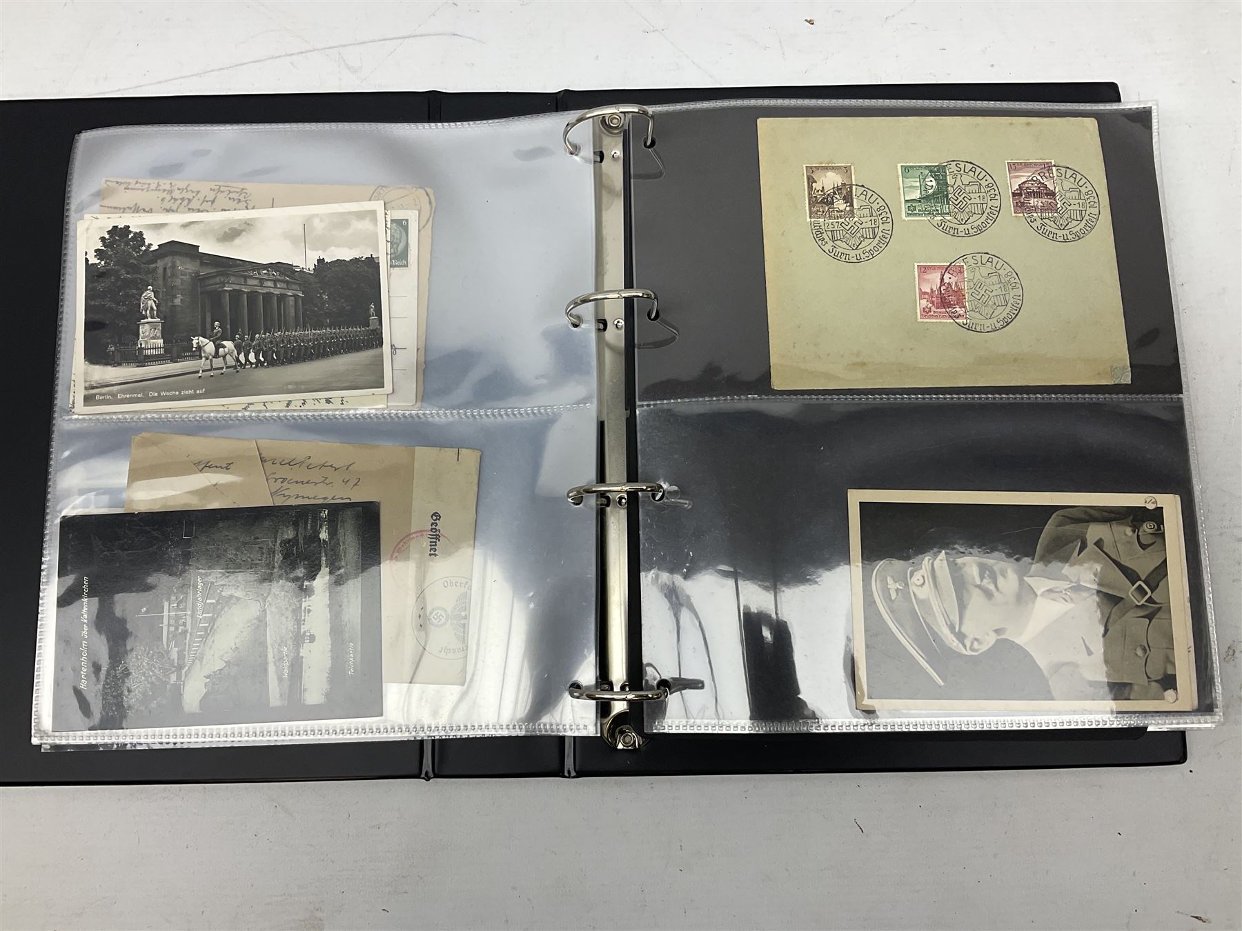 Modern loose leaf album of WW2 German postcards, photographs and other paper ephemera including Adolf Hitler, Luftwaffe, comic, soldier and group portraits, memorial cards, propaganda images, interesting postmarks etc