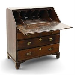 Georgian oak bureau, fall front with pierced brass escutcheon and handles, revealing a fitted interior, above two short over two long drawers, raised on bracket feet
