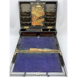  A 20th century Chinese black lacquer and gilt detailed writing box, decorated with figures, pagodas and cranes amidst a mountainous landscape, the hinged cover opening to reveal a compartmented interior and fold out baize lined slope, H20cm L46.5cm D31.5cm.   