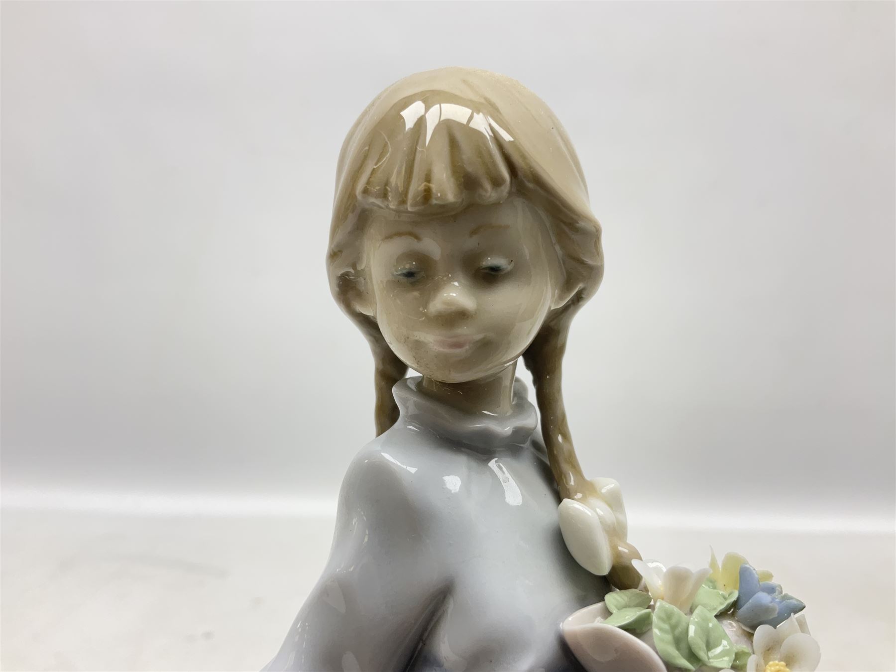 Three Lladro figures comprising, Pocket Full of Wishes no 7650, School Days no 7604 and Spring Bouquets no 7603, all with original boxes, largest example H26cm  