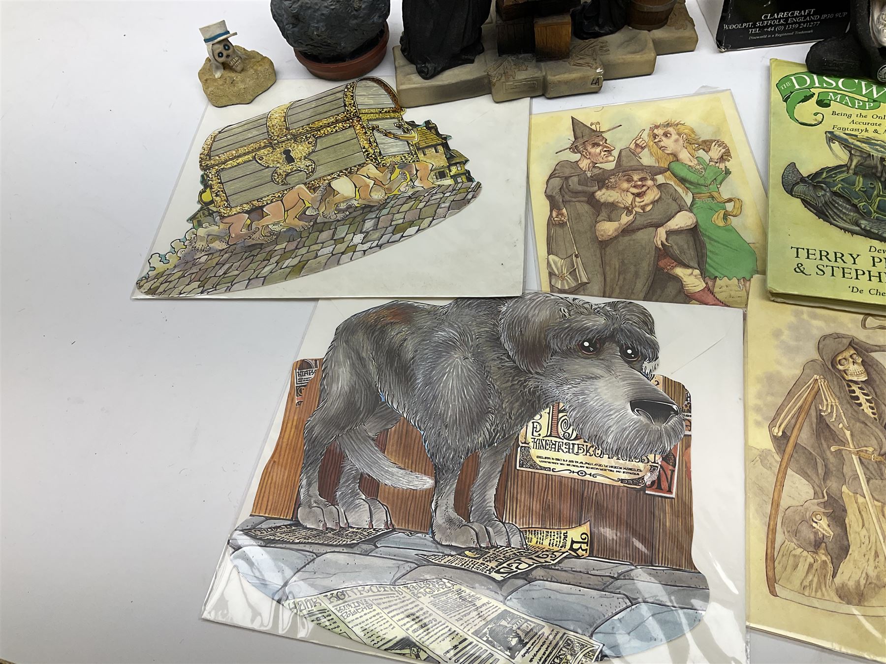 Terry Pratchett Discworld figures, designed by Clarecraft, comprising Death and Granny Weatherwax, DW90, Deathhead DWE8, Dried-frog pill box, boxed, DW63, Death as Beau Nidle, boxed, DW88, Agnes Nitt DW68, Detritus, DW22, Bonsai mountain, DW78, Volcanic bonsai mountain, boxed, DW79, Bonsai mountain valley, DW80, together with the Discworld mapp, and a collection of Terry Pratchett cards.  