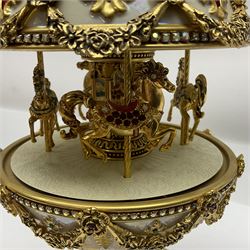 Franklin Mint House of Faberge; The Faberge Imperial Carousel Egg, with a carousel that revolves to the sound of the musical box operated by the winding key finial, H27cm